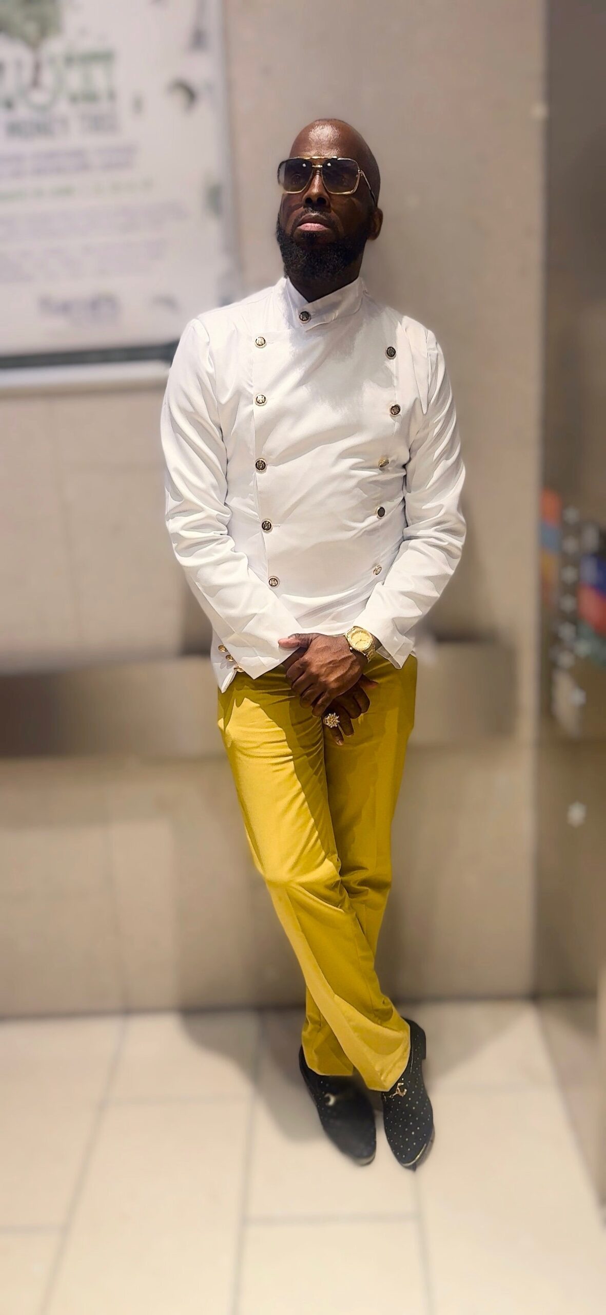 Corey Wims in a white jacket and yellow trousers